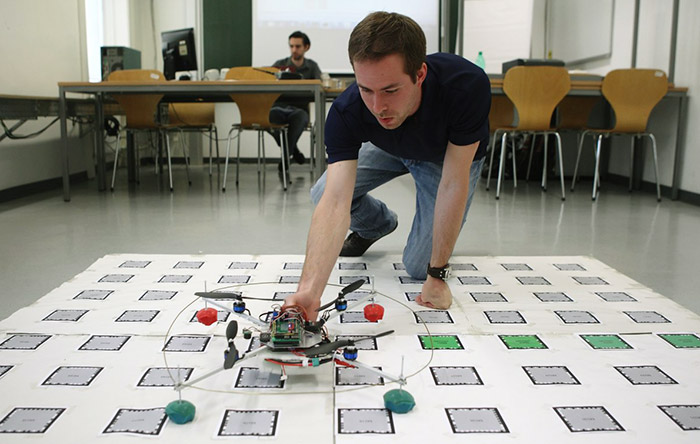 9-austria-Student-Michael-Leichtfried-of-the-Virtual-Reality-Team-at-Vienna-University-of-Technology-places-a-quadcopter-on-a-map-marked-with-computer-readable-symbols