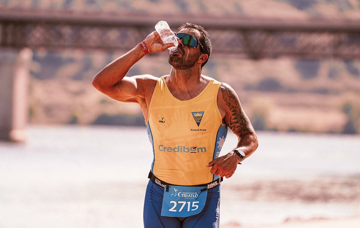 مرد ورزشکار در حال دویدن و خوردن مایعات ایزوتونیک